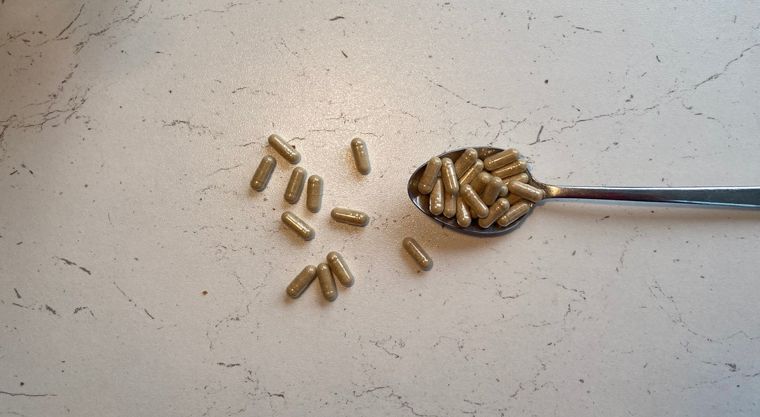 Vitamin capsules on a spoon