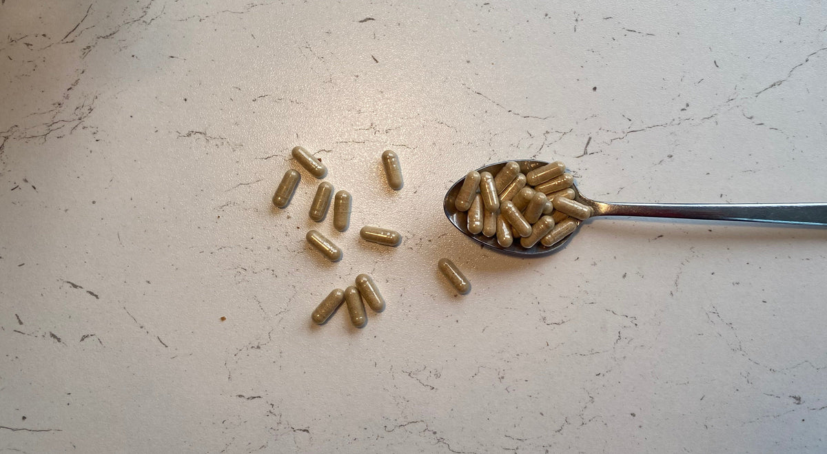 Vitamin capsules on a spoon
