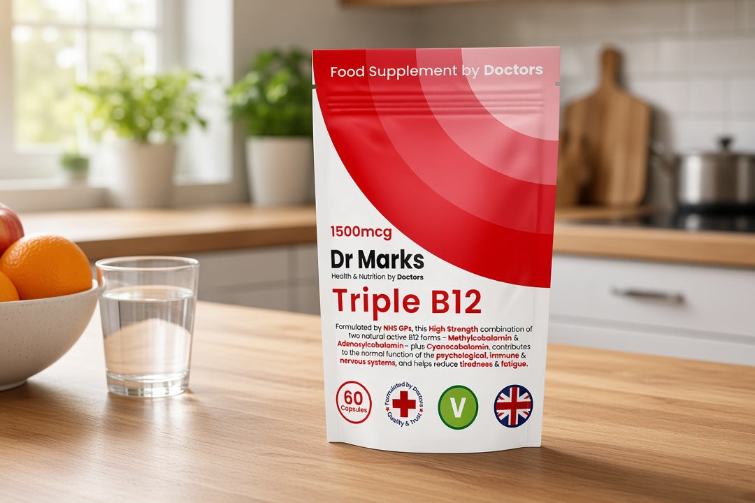 Dr Marks Triple B12 pouch on a kitchen counter beside a bowl of fruit and a glass of water