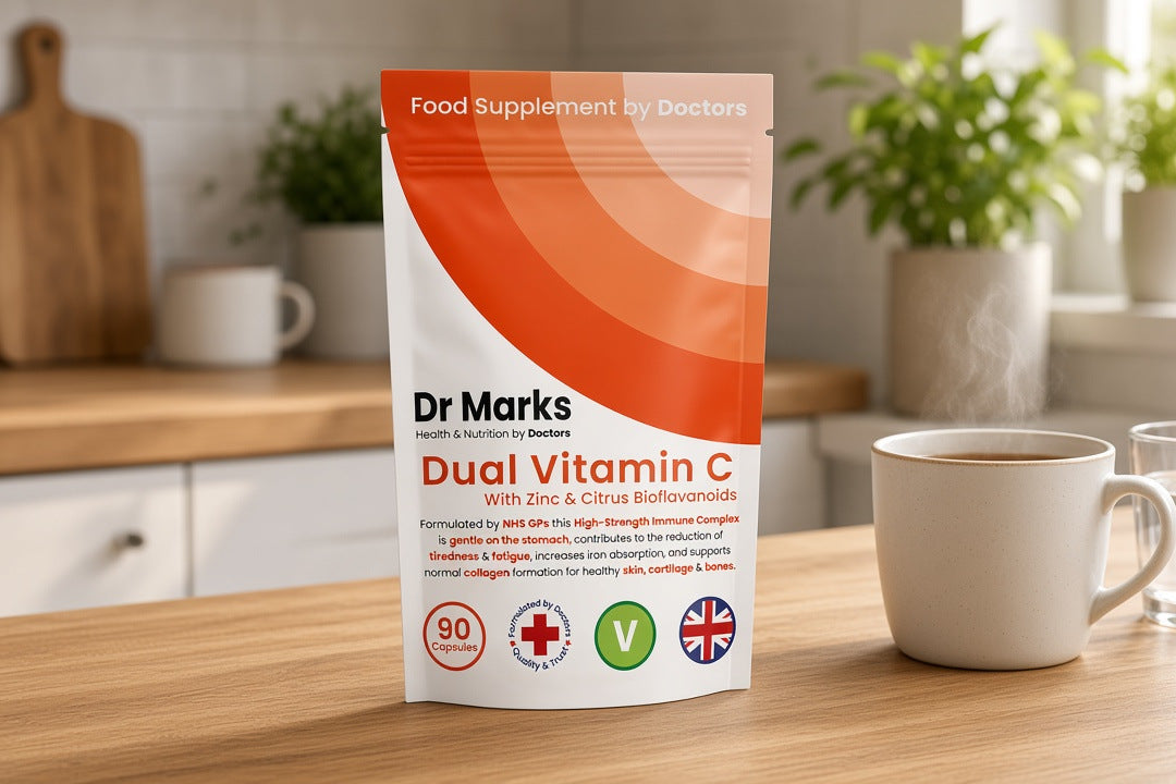 Dr Marks Dual Vitamin C with Zinc pouch on a kitchen table beside a mug and glass of water